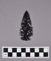 Obsidian projectile point, side-notched, mended