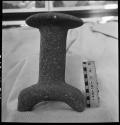 Stone mushroom or stool. 3 short feet. Grey, granite rock. Max ht=26 cm. Diam of