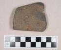 Ground stone, partially perforated fragment