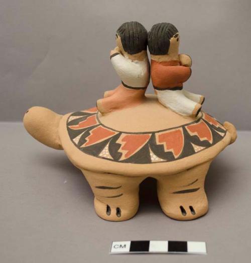 Ceramic turtle with two children on its back