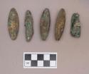 Metal, copper alloy rolled oval objects and fragments; shell beads adhered to one copper object