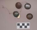 Metal, copper alloy ornaments, domed, two perforations each, two possibly silver plated, possible buttons; three objects strung on wire