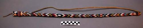 Quirt or riding whip.  Made of wood and leather with multi-colored beadwork.