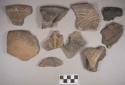 Ceramic, earthenware body, rim, and handle sherds, some incised, some cord-impressed, some punctate, some with combination of decorations, some with incised handle, some with incised rim, two with molded lizard effigy, one animal effigy lug, shell-tempered; some sherds crossmended with glue; some sherds crossmend