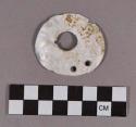Organic, shell ornament, discoidal, one large central perforation and two smaller perforations, possible gorget