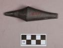 Ground stone, worked stone object, tapered at both ends, flat on one side