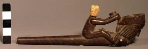 Pipe, purple slate; head of human figure carved from piece of whale's tooth