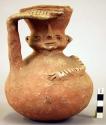 Pottery jar, handle on side, red clay, human face