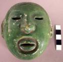 CAST, moulded and incised human head and facial features, green pigment