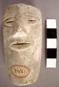 Cast of moulded and incised human facial features, chipped