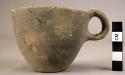 Undecorated pottery cup with handle