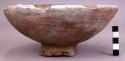 Shallow reddish-gray pottery bowl, coarse tempered, small pedestal