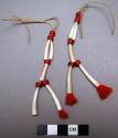 Woman's earrings of dentalium shells and red glass beads with tassels of red yarn