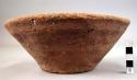 Ceramic bowl, coarse red ware, flat base, splayed sides, pitted surface