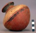 Pottery jar, red, with white band and black ornament