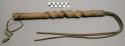 Quirt, possibly from the Plains. Wood handle carved like a corkscrew.