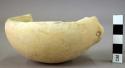 Ground stone bowl, white marble, perforated lug handle, fragment missing