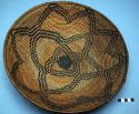 Basket. 3 rod coiled. Flower or star design which surrounds anothor one