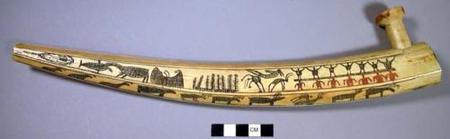 Walrus ivory pipe; etched with houses, boats, etc..