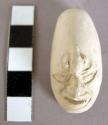 CAST, moulded and incised human head, facial features, headdress