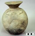 Ceramic jar, wide flaring rim, rounded base, moulded animal figure