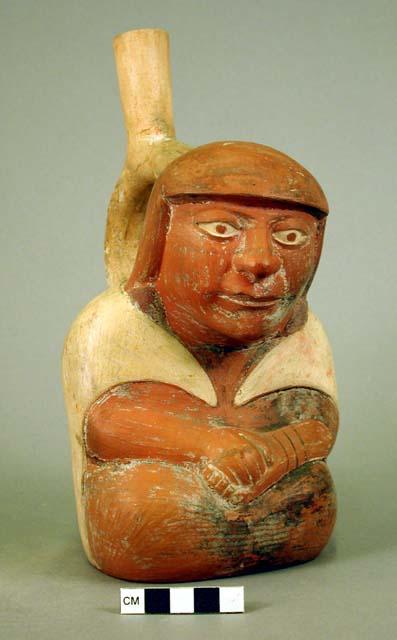 Ceramic bottle, stirrup spout, human effigy, molded face, arms and hands
