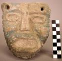 Ground stone sculpture, carved human head with facial features