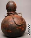 Gourd container, grass collar, leather strap, approximate height 13 in.