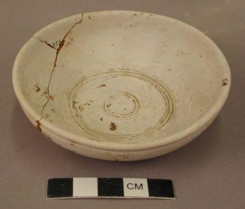 Small saucer of white ware-concerntric circle pattern inside