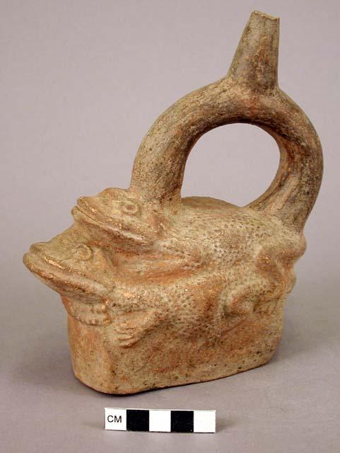 Stirrup pot of redish tinge; mating frogs