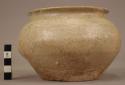 Small urn of greyish white ware - traces of glaze