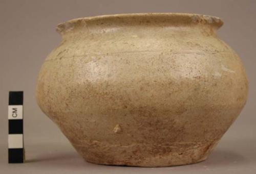 Small urn of greyish white ware - traces of glaze