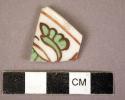 Red, green and white rim potsherd - floral and geometric designs