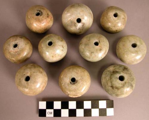 Ground stone beads, round, greenstone, perforated at center