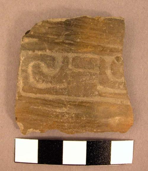 Rim potsherd of black stamped ware with red painted bands