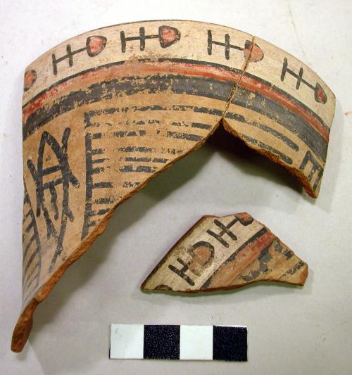 Sherds of a vase painted in polychrome with fish and geometric motifs