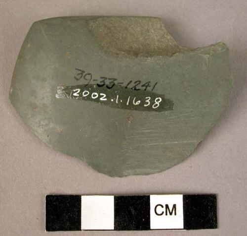 Ground stone axe fragment, tip of blade only, green, polished on one side