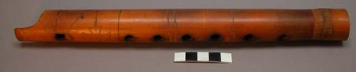 Flute of thick bamboo with 6 holes on one side and 2 on the other