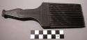 Comb, carved wood, incised & punctate designs on asymmetric handle