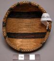 Basket, rounded body, lipped rim, woven dark & natural stripe & check designs
