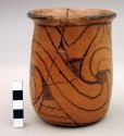 Vase-shaped pot. Spirals and thin watery black lines on red. 12x9.5x9.5 cm.