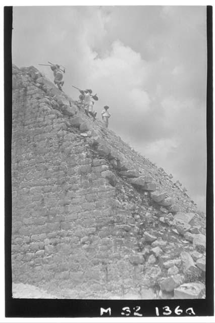 Workmen ascending northeast corner of Main Stairway at Monjas