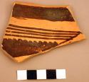 Ceramic rim sherd, redware, black painted geometric design