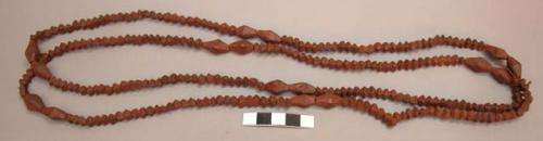 Double strand string of hand carved wooden beads