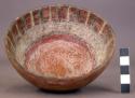 Bowl with red and white designs inside