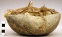 Gourd bowl filled with raw cotton & plant fibers