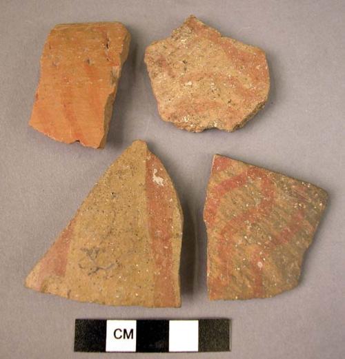 4 potsherds - "brittle orange"  buff ware with wavy vertical lines painted in re