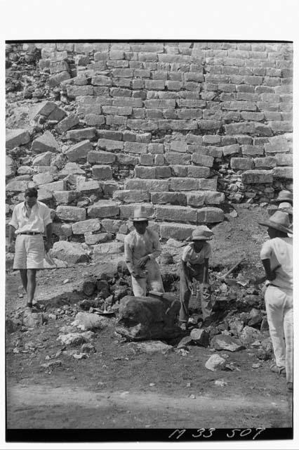 Unearthing Chac Mool at base of main stairs at Monjas, photo from the north