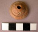 Ceramic spindle whorl with incised decoration