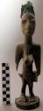 Female ibeji, with large breasts and peaked coiffure, wood, with blue bead brace